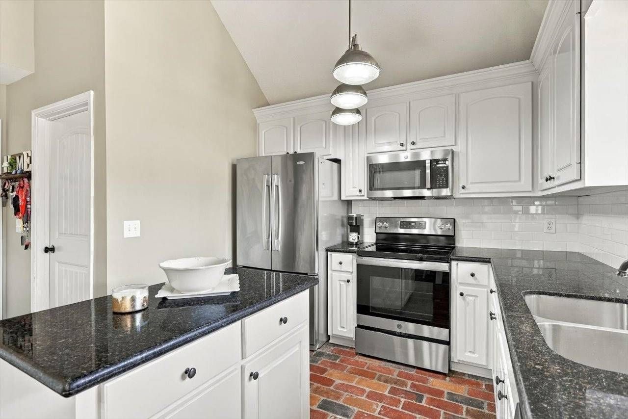 Kitchen with white cabinets and stainless appliances
