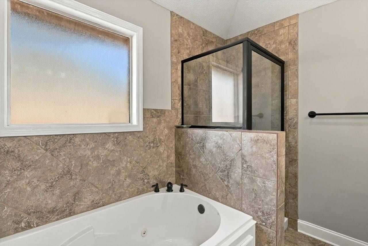 Primary bathroom with soaking tub and separate shower